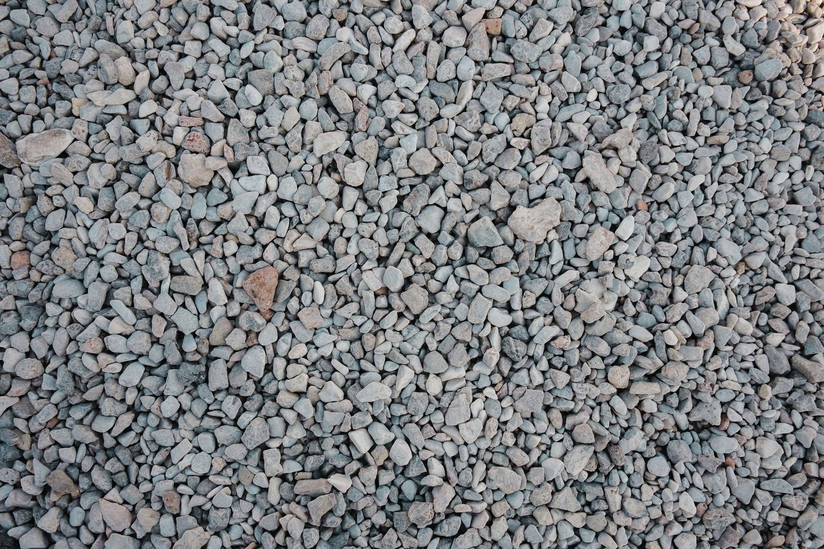 Close-up of graded gray aggregate stones for a drainage sub-base