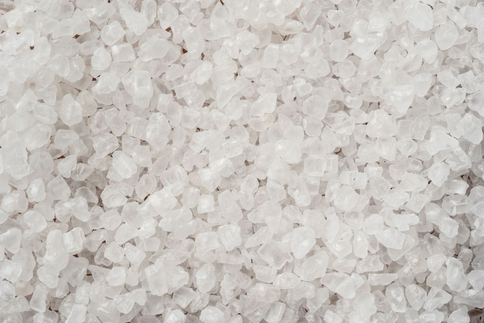 Close-up of coarse white de-icing salt crystals in a pile