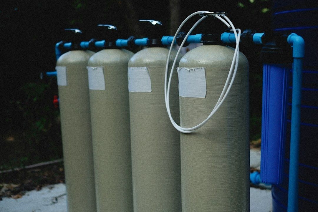 Commercial water softener tanks with blue piping and white tubing